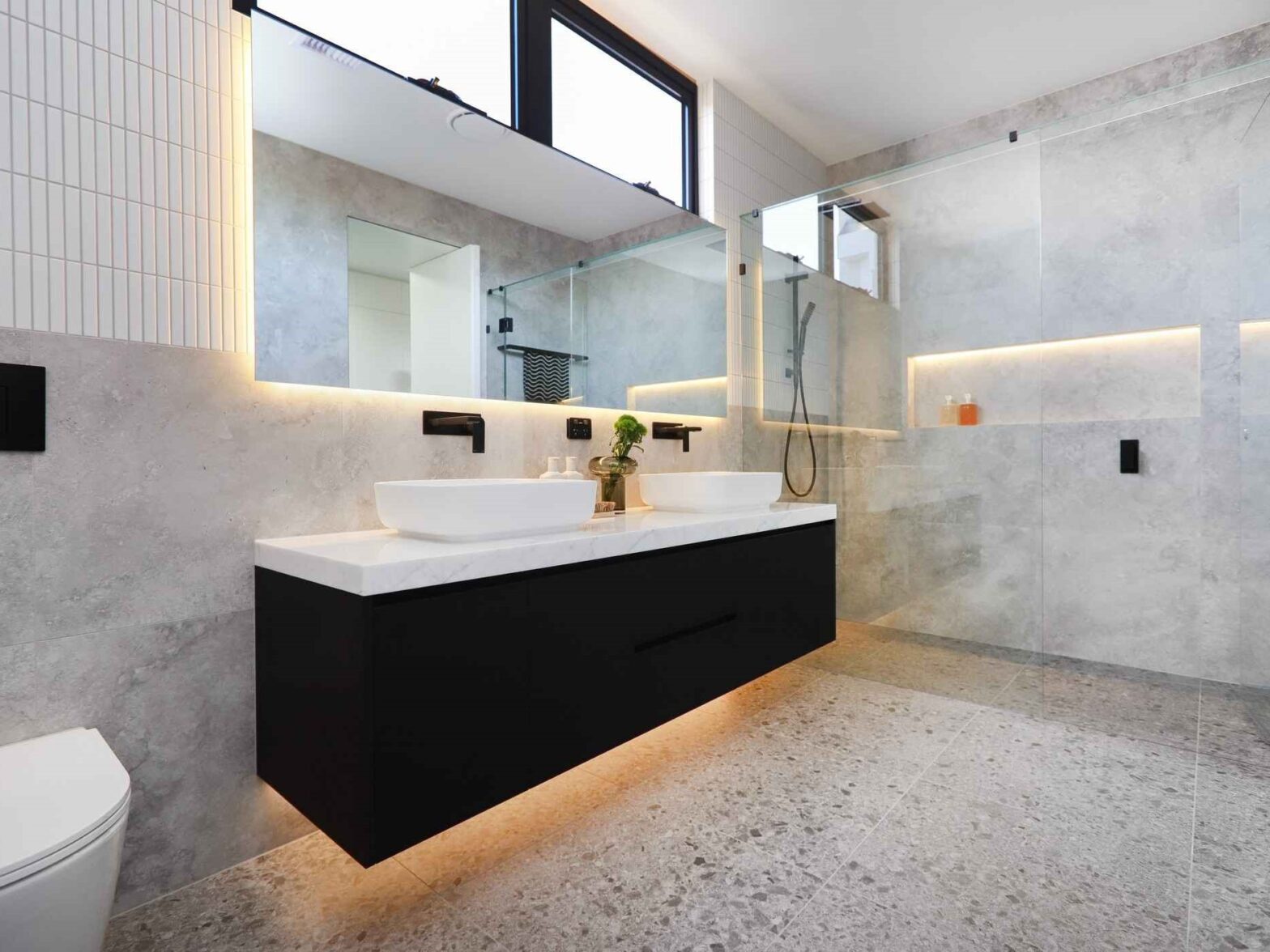 bathroom with gray-ish walls and black cabinets